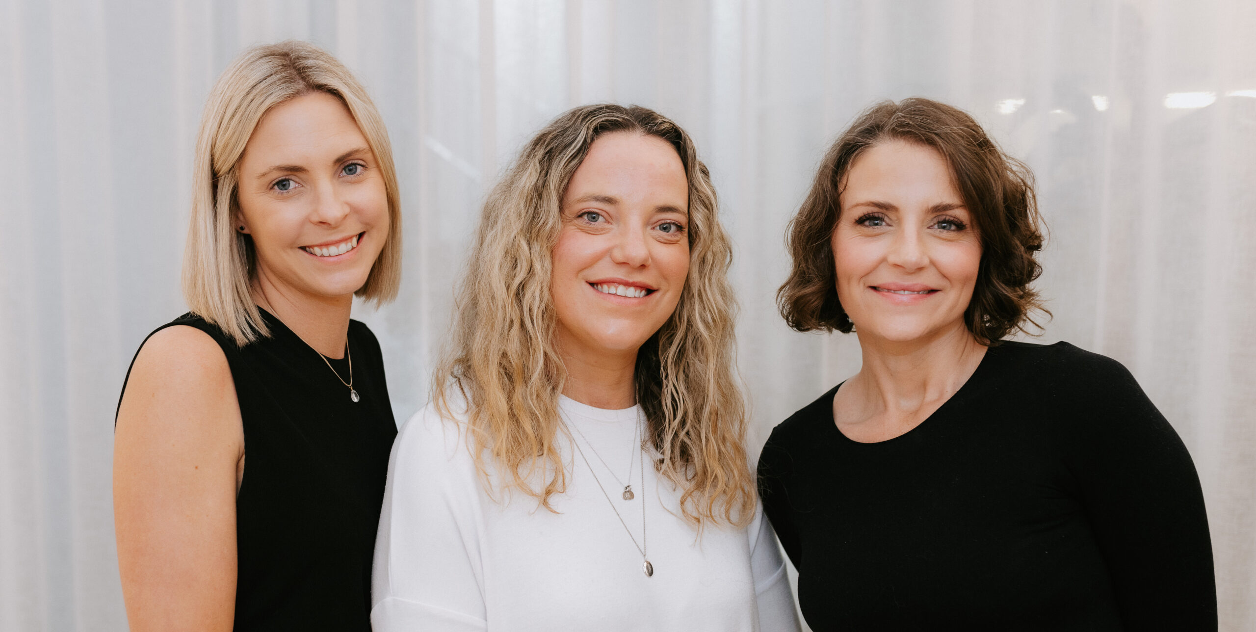 three naturopaths standing next to each other smiling at the camera