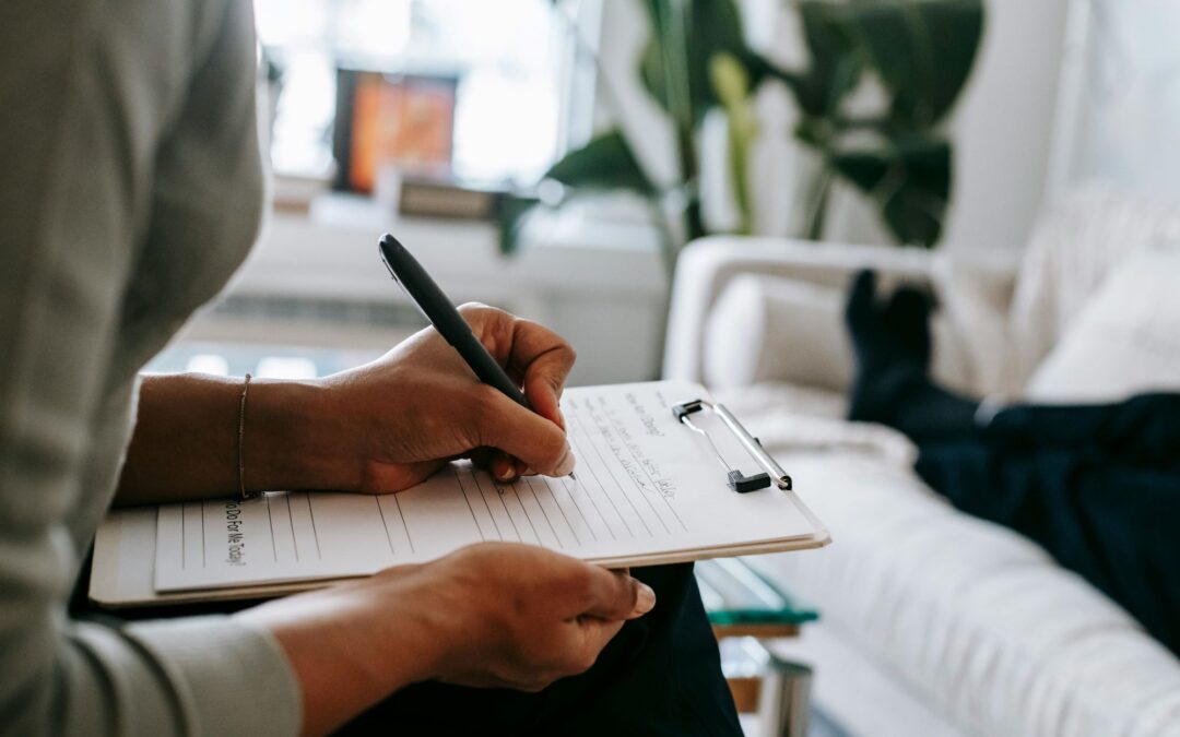 person sitting with clipboard on lap writing on it